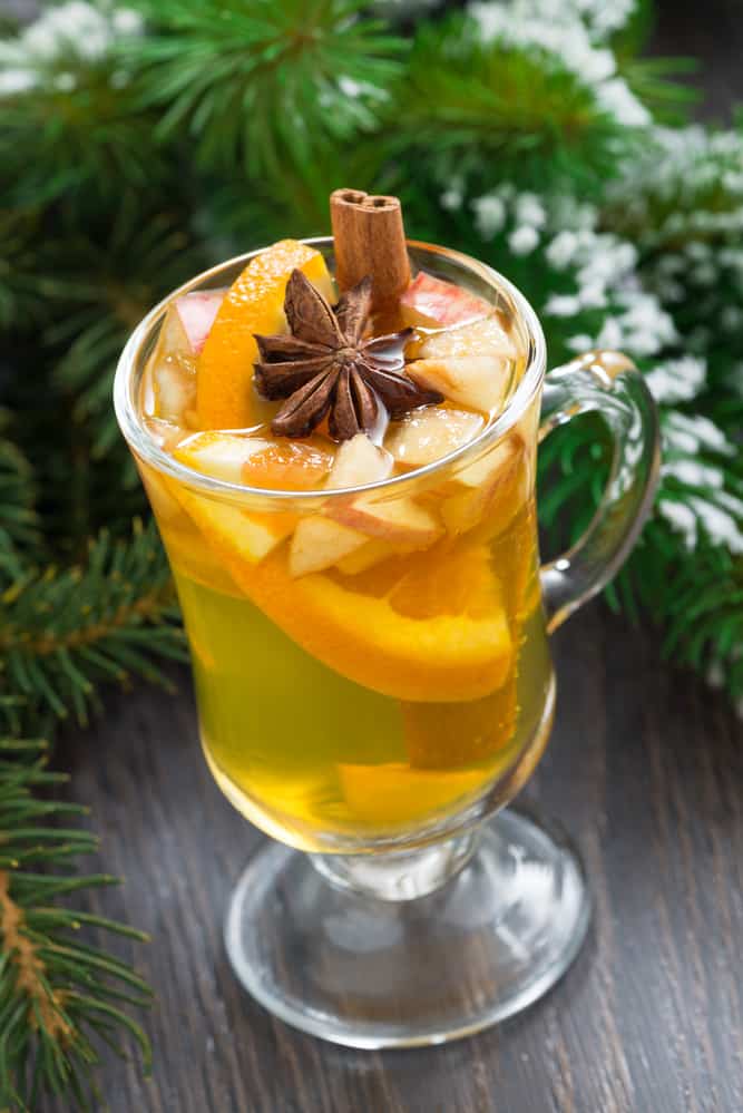 spiced apple cider in a glass on a wooden background